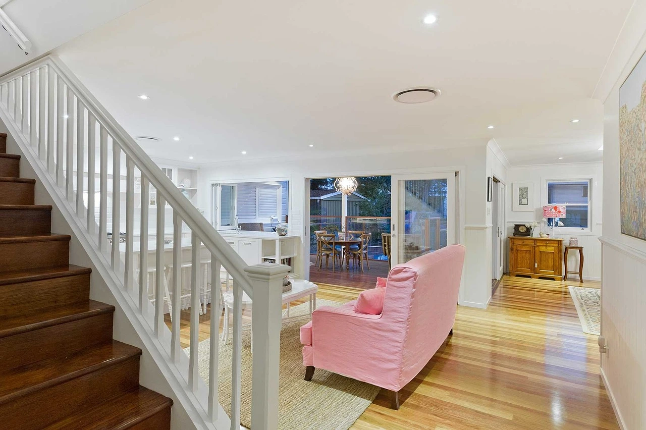 Rénovation intérieure moderne avec escalier en bois et salon lumineux